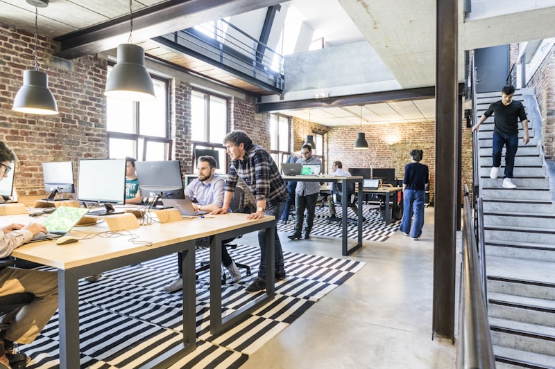 A bright open office with engineers working across shared desks.